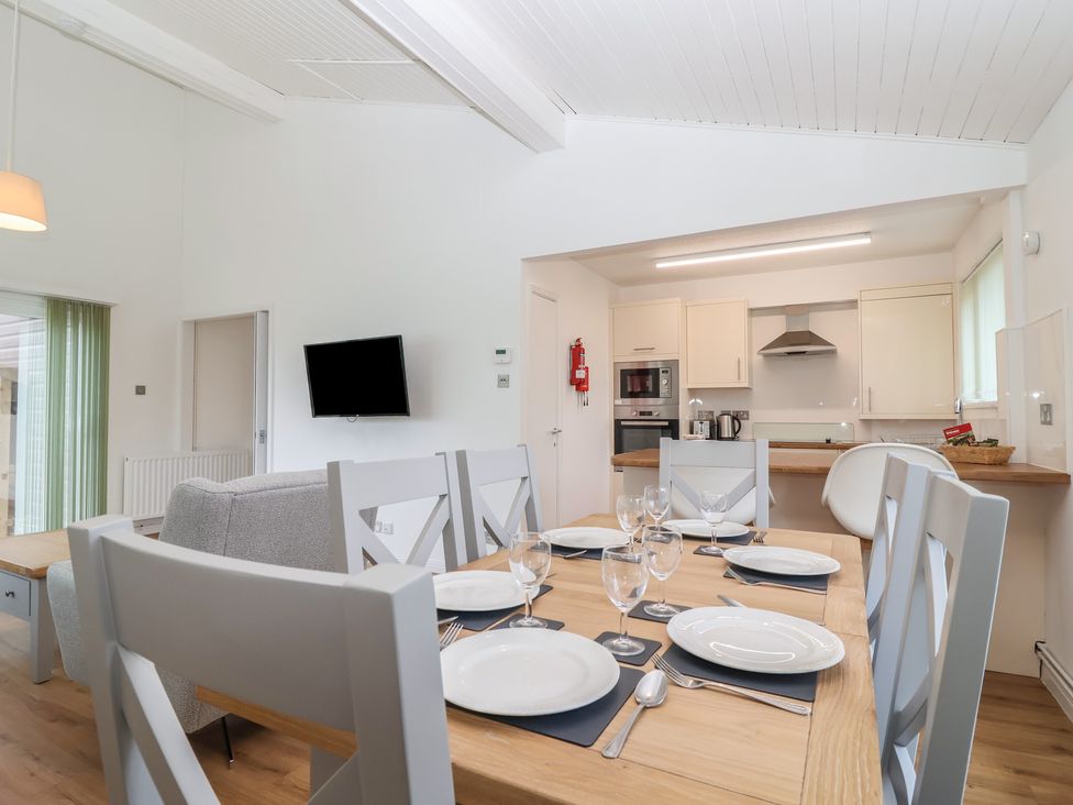 A dining room with a table set for meals at Harcombe House Bungalow 25 Chudleigh