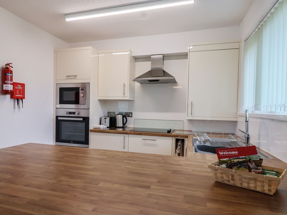 A kitchen with appliances and cabinets at Harcombe House Bungalow 25, Chudleigh