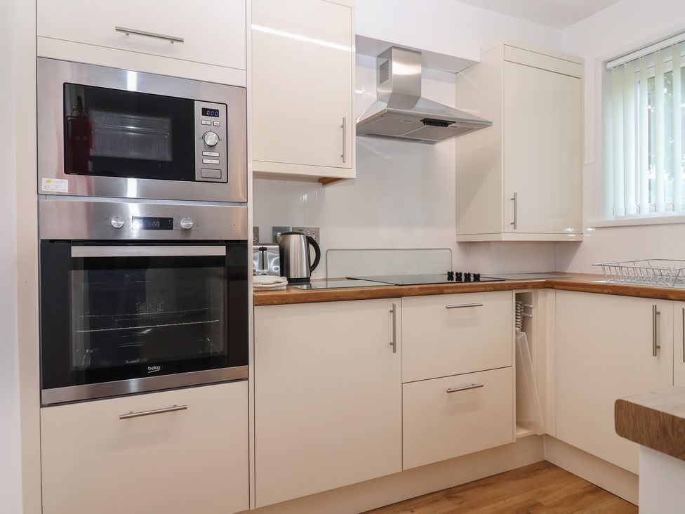 A kitchen with appliances and cabinets at Harcombe House Bungalow 25 Chudleigh