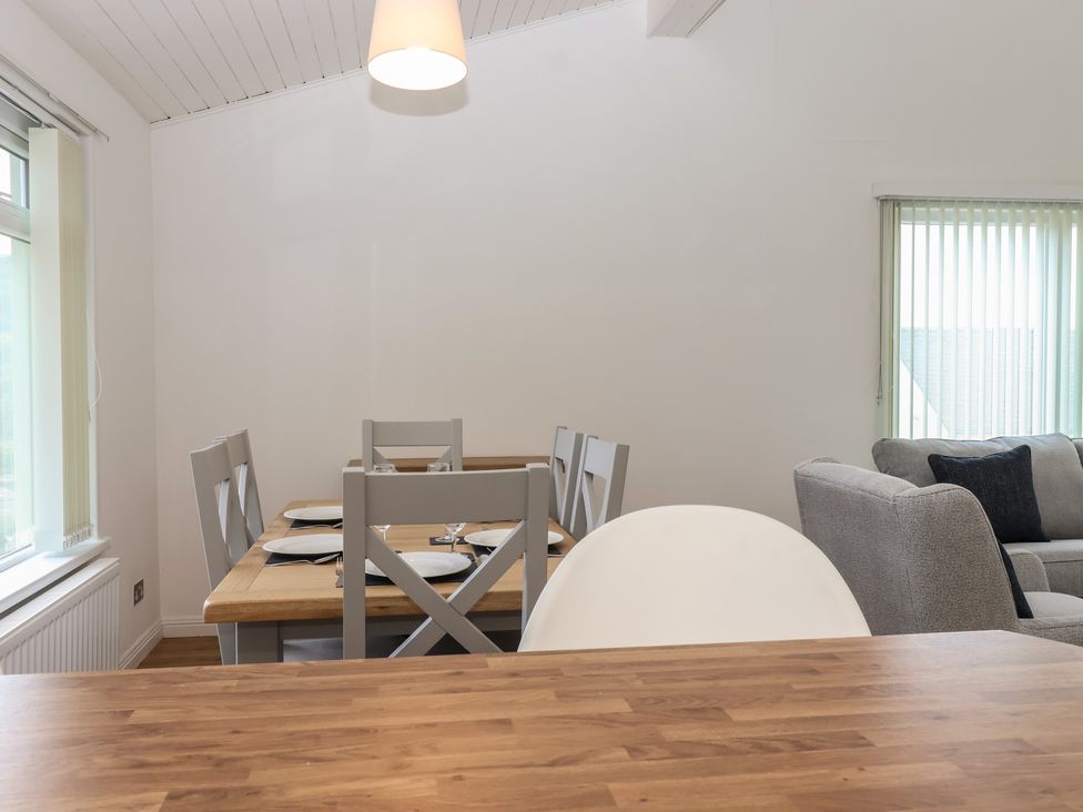 A dining area with a table and chairs at Harcombe House Bungalow 25 Chudleigh