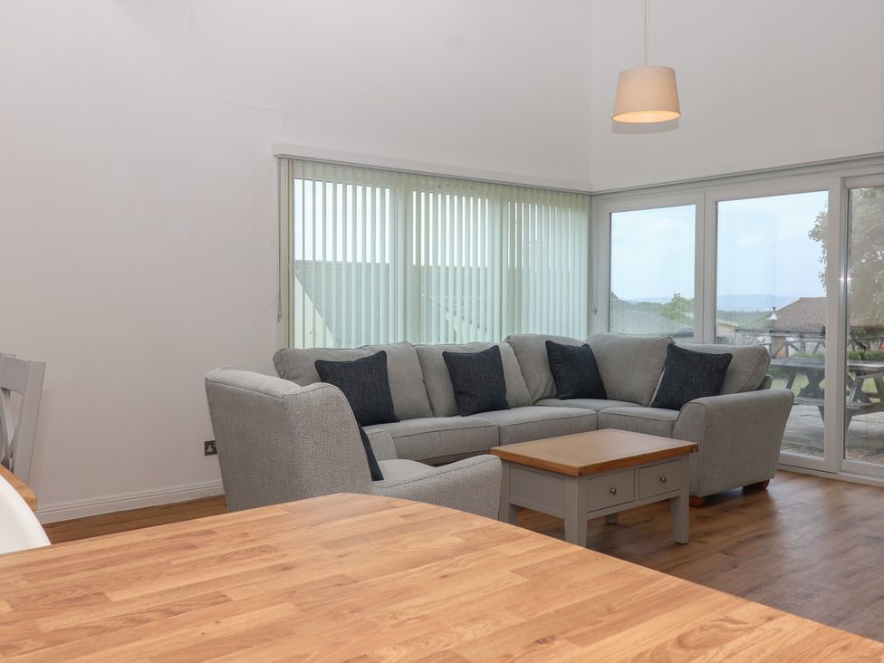 A living room with a sofa and coffee table at Harcombe House Bungalow 25 Chudleigh