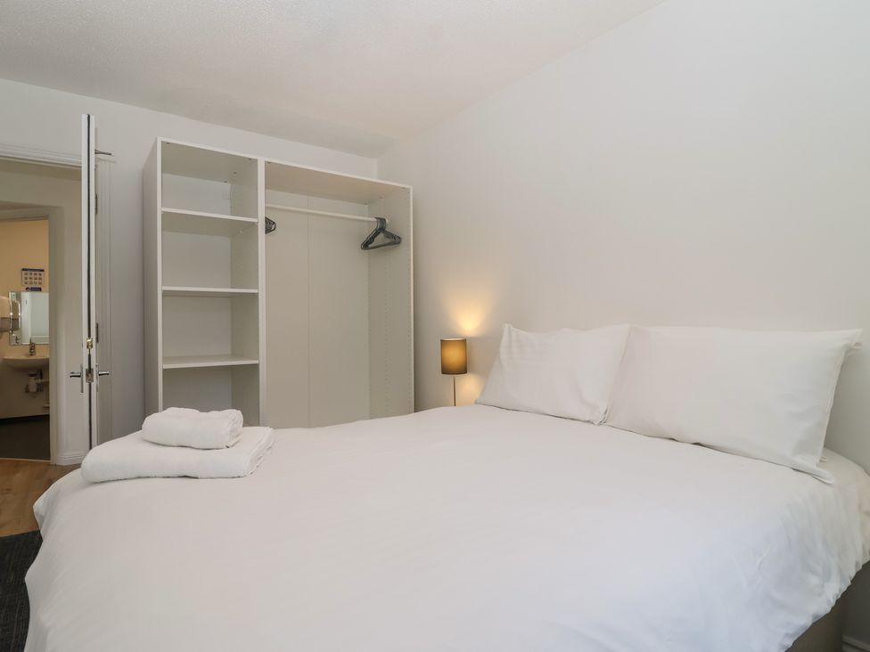 A bedroom with a bed and closet at Harcombe House Bungalow 25 in Chudleigh