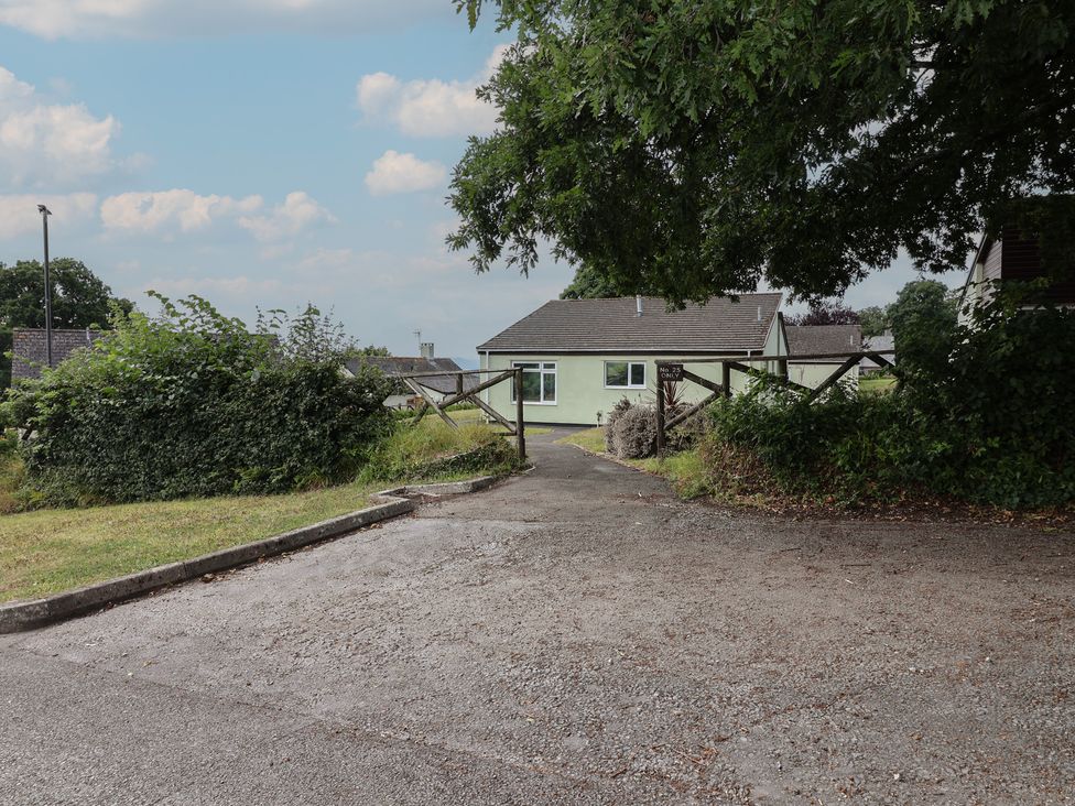 A house with a driveway and gate at Harcombe House Bungalow 25 Chudleigh
