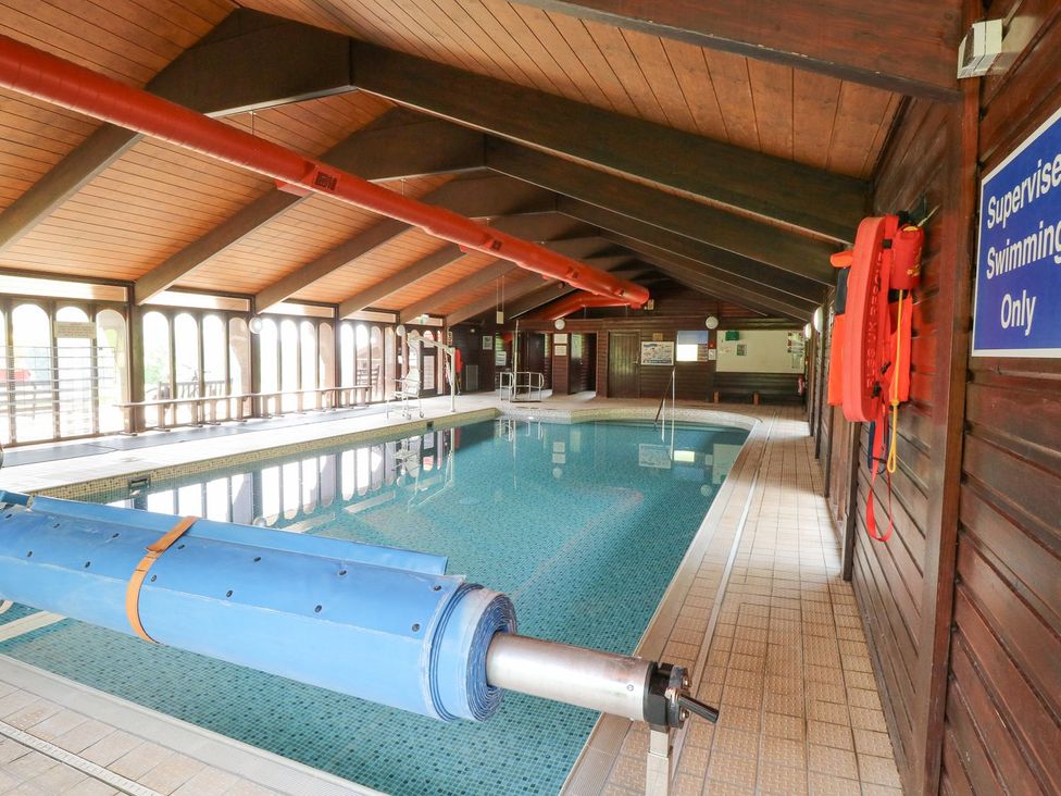 An indoor pool area with swimming equipment at Harcombe House Bungalow 25 Chudleigh