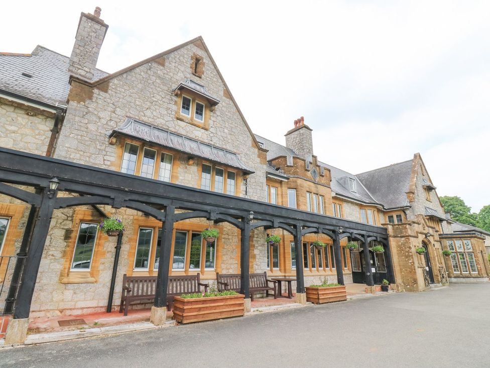 A building with benches and flower pots at Harcombe House Bungalow 25 in Chudleigh