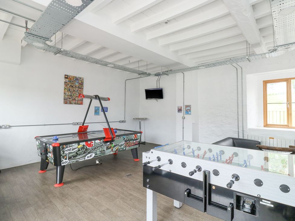 A game room with air hockey and foosball tables at Harcombe House Bungalow 25 in Chudleigh