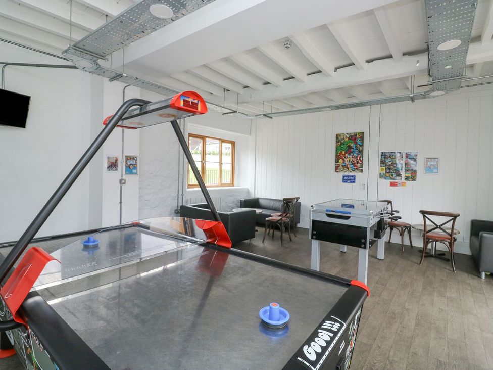 A game room with air hockey and foosball tables at Harcombe House Bungalow 25 Chudleigh