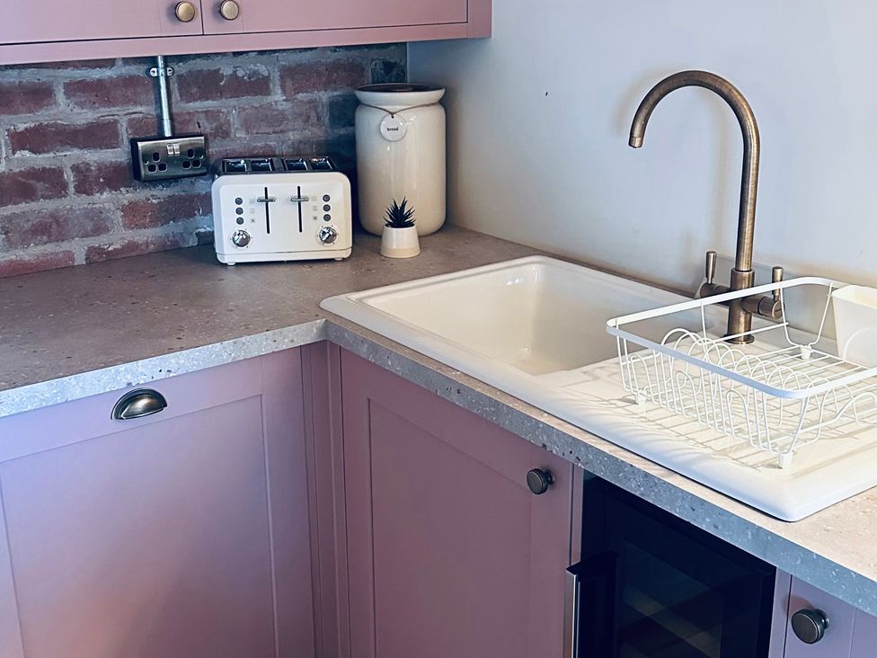 A kitchen with a sink and toaster at Farnah House Barn Duffield
