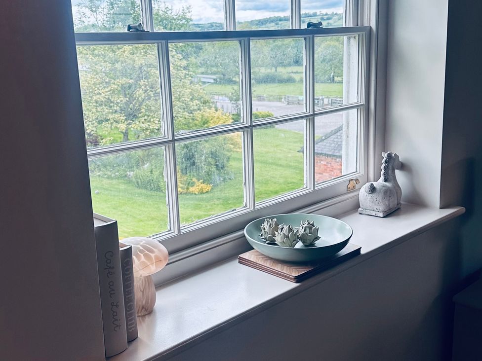A window with decorative items on the sill at Farnah House Barn in Duffield