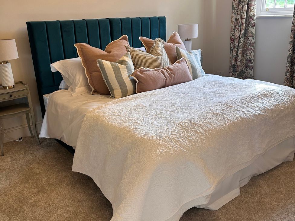 A bedroom with a bed and pillows at Farnah House Barn in Duffield