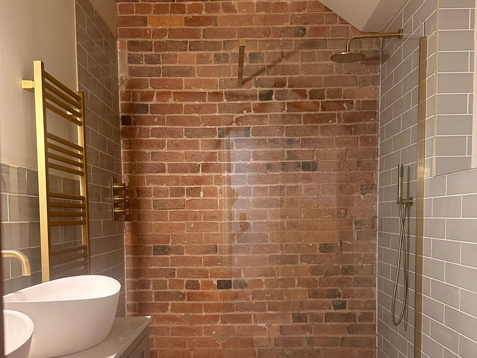 A bathroom featuring a shower and sink at Farnah House Barn in Duffield