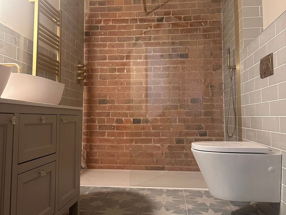 A bathroom with a sink, toilet, and shower at Farnah House Barn Duffield