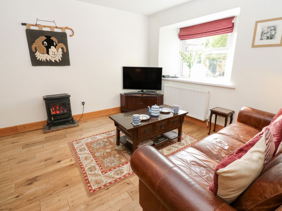 A living room with a sofa and coffee table at Bridge House