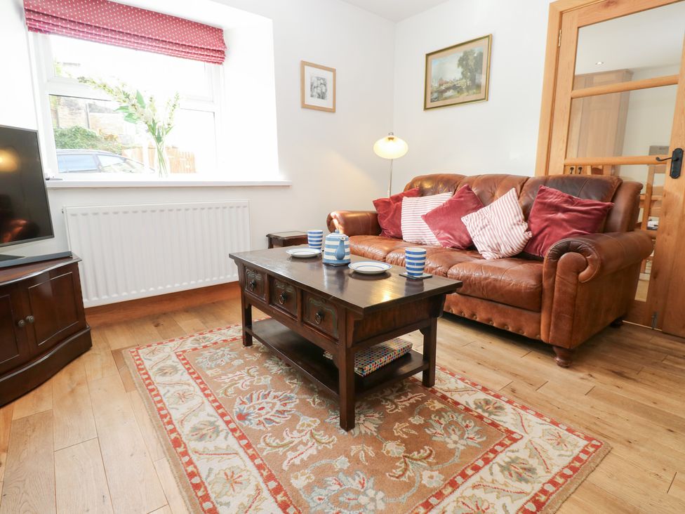A living room with a sofa and coffee table at Bridge House