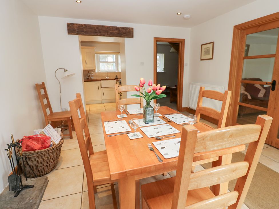 A dining room with a wooden table and chairs at Bridge House