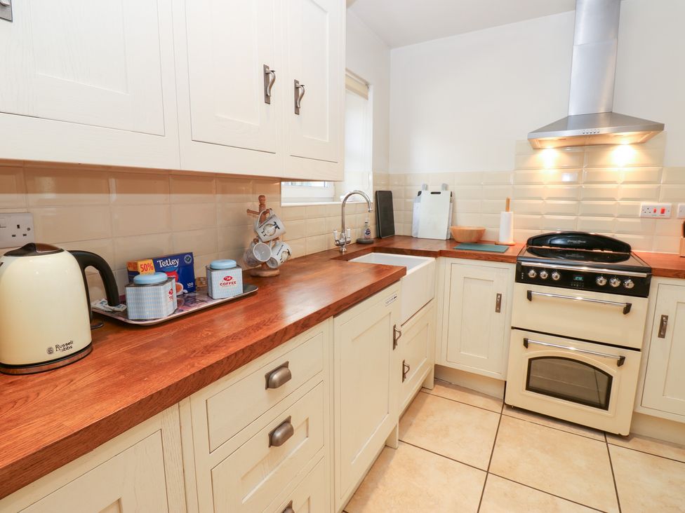A kitchen with a sink and stove at Bridge House