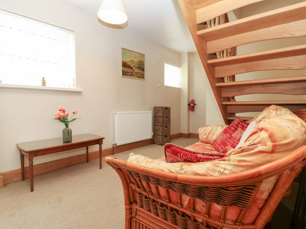 A living room with a sofa and table at Bridge House