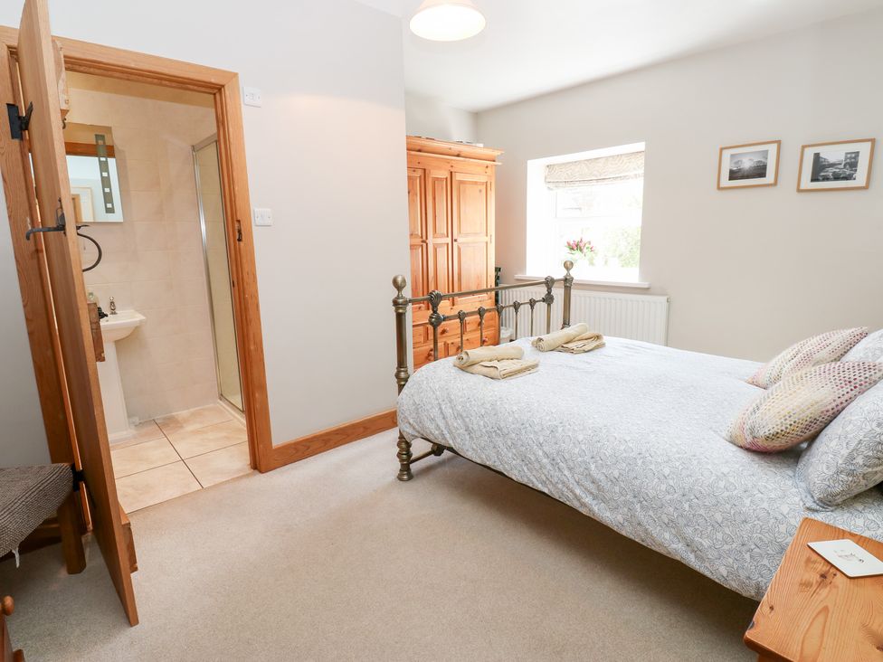 A bedroom with a bed and wardrobe at Bridge House 