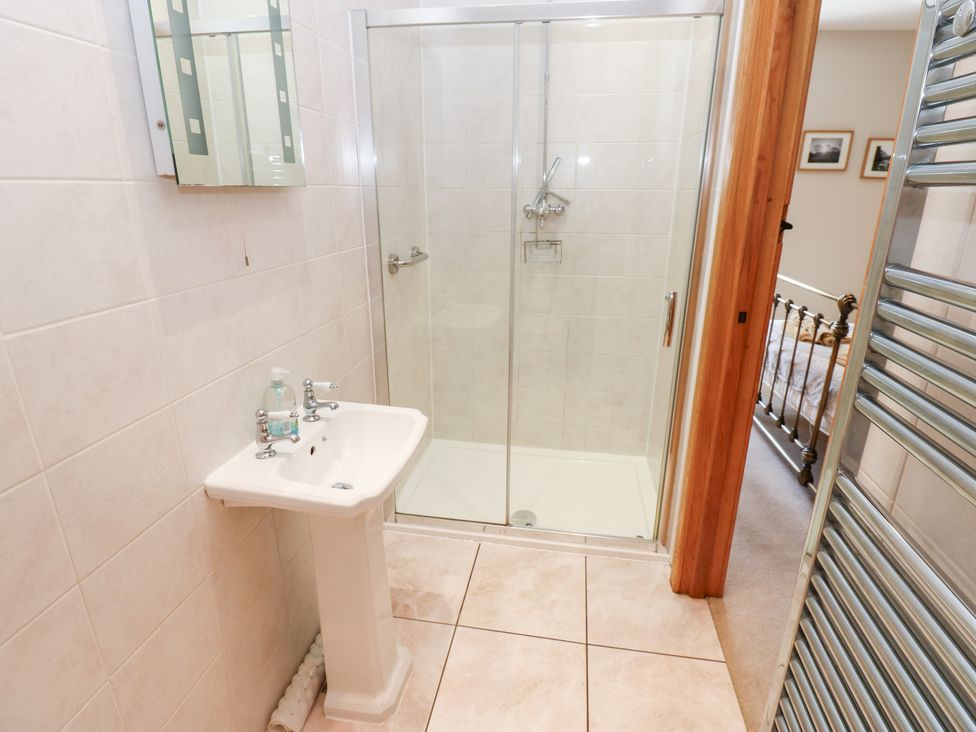A bathroom with a sink and a shower at Bridge House 