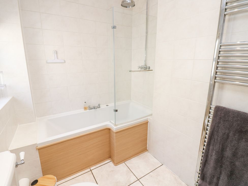 A bathroom with a bathtub and shower at Bridge House