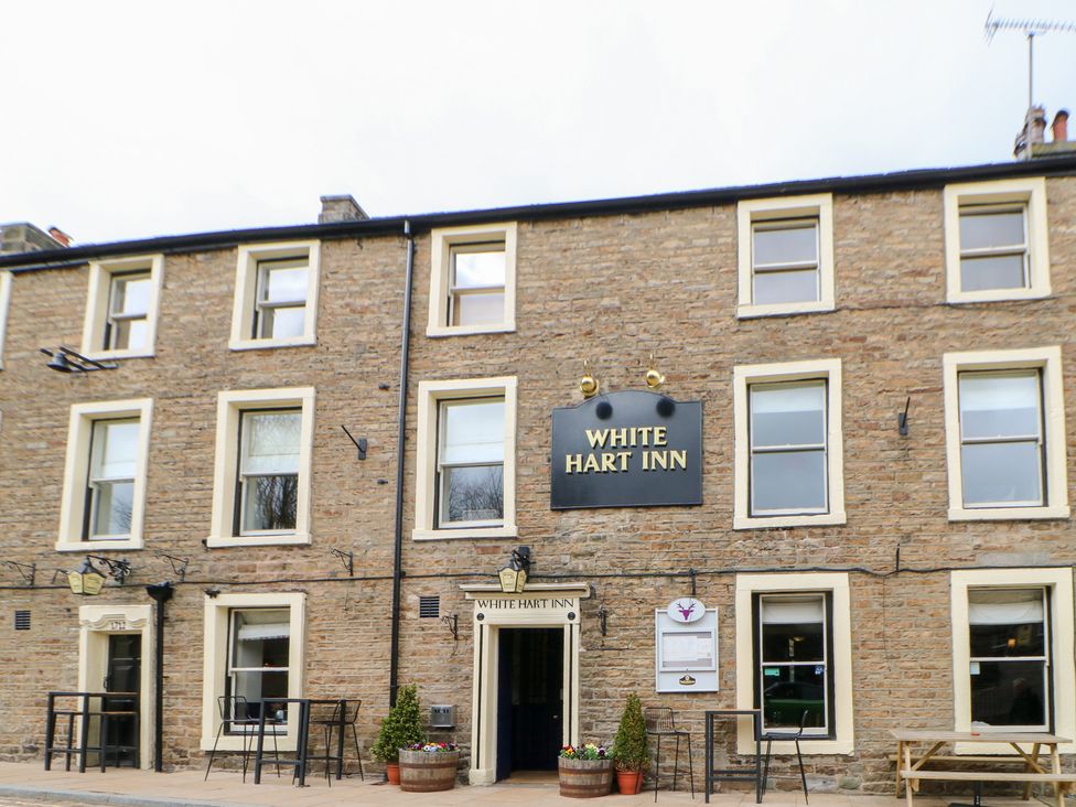 A building facade of the White Hart Inn with outdoor seating