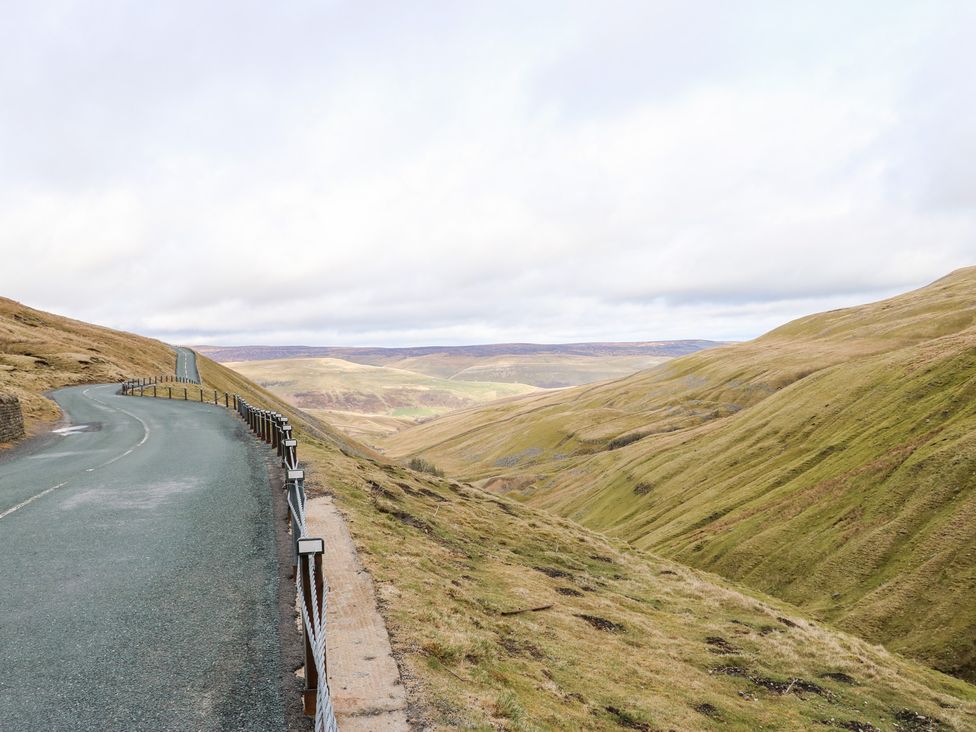 A road along hills and grassland at Bridge House