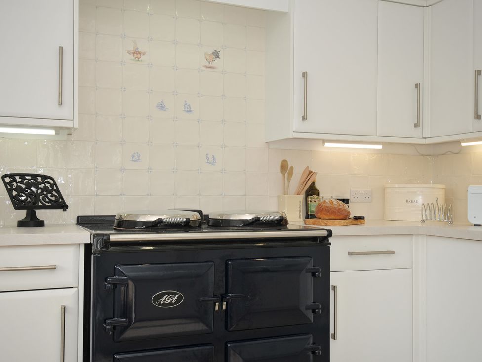 A kitchen with an AGA stove and countertop appliances at 42 Little Trelyn Wadebridge