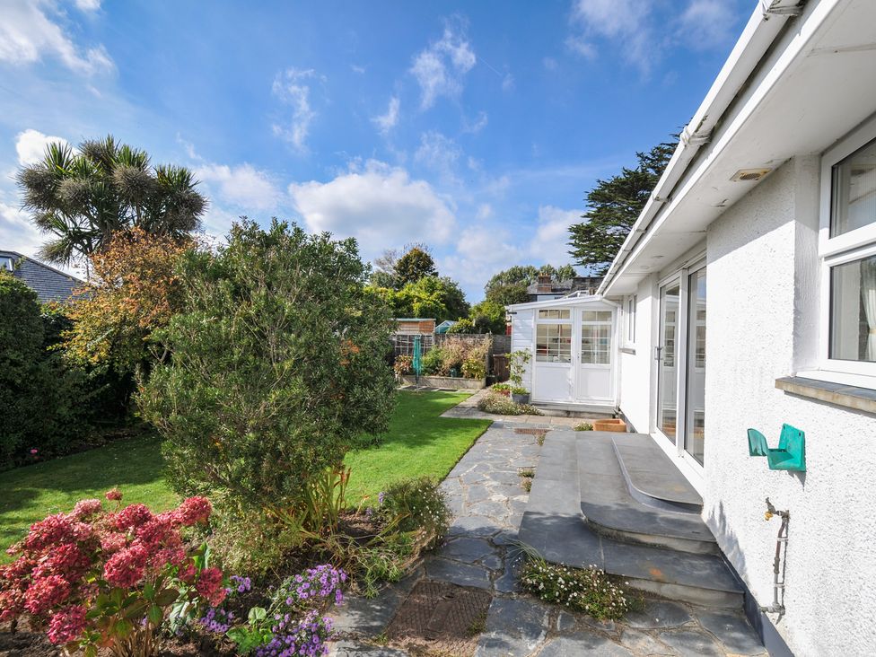 A garden with plants and stone pathway at 42 Little Trelyn Wadebridge