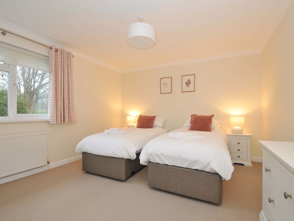 A bedroom with two beds and a window at 42 Little Trelyn in Rock