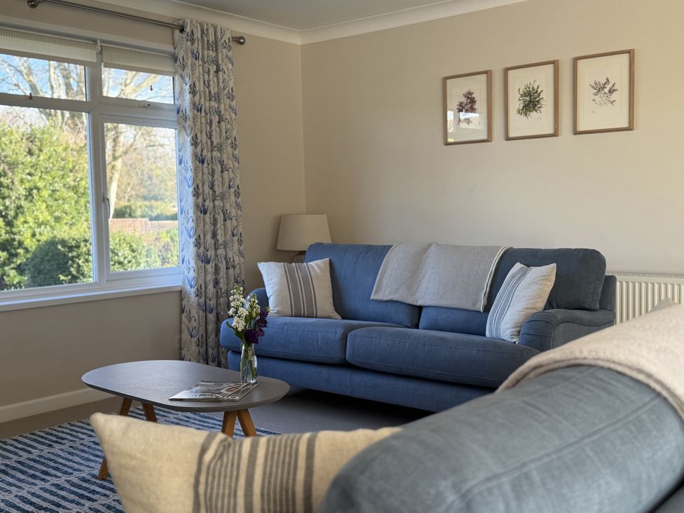 A living room with a sofa and coffee table at 42 Little Trelyn, Rock