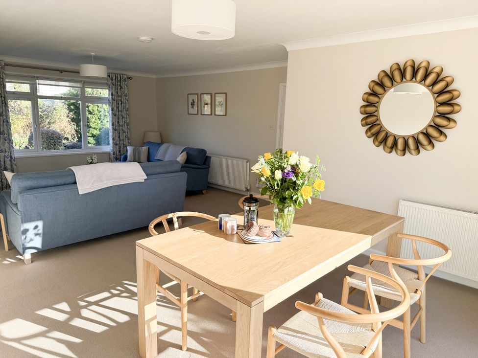 A living room with a sofa and dining table at 42 Little Trelyn in Rock