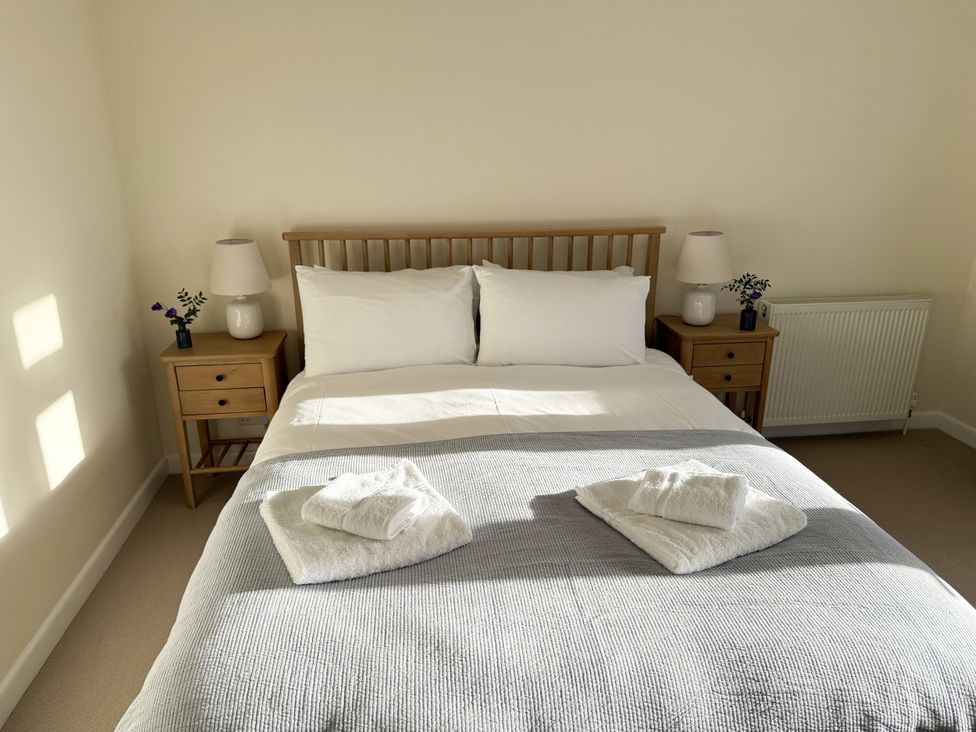 A bedroom with a bed and bedside tables at 42 Little Trelyn in Rock