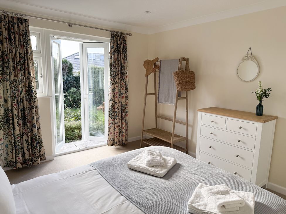 A bedroom with a bed and a dresser at 42 Little Trelyn Rock
