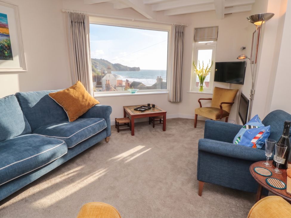 A living room with a view and furniture at Iveridge in Sandsend