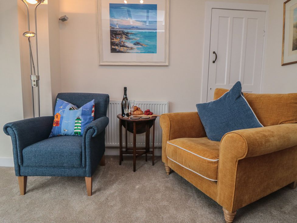 A living room with two armchairs and a small table in Iveridge Sandsend