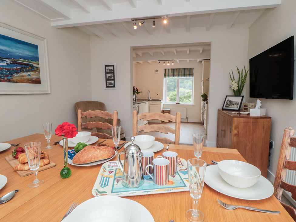 A dining room with a table set for a meal at Iveridge in Sandsend
