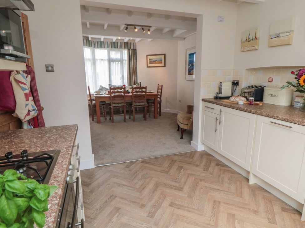 A kitchen leading to a dining area with a table and chairs at Iveridge Sandsend