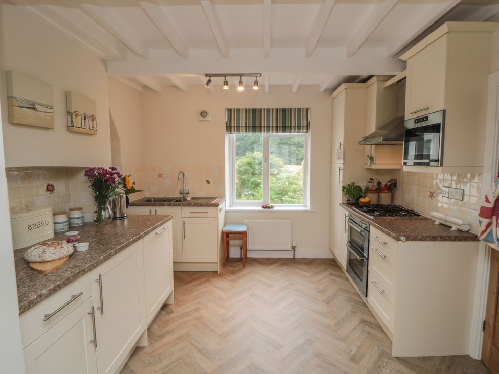 A kitchen with a sink and stove at Iveridge Sandsend