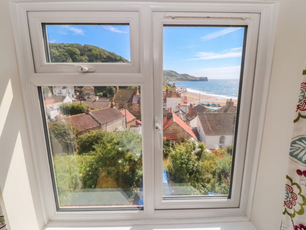 A view from a window overlooking houses and the beach at Iveridge Sandsend