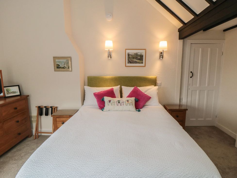 A bedroom with a bed and nightstands at Iveridge in Sandsend