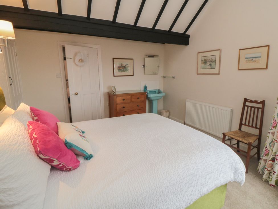 A bedroom with a bed and dresser at Iveridge Sandsend