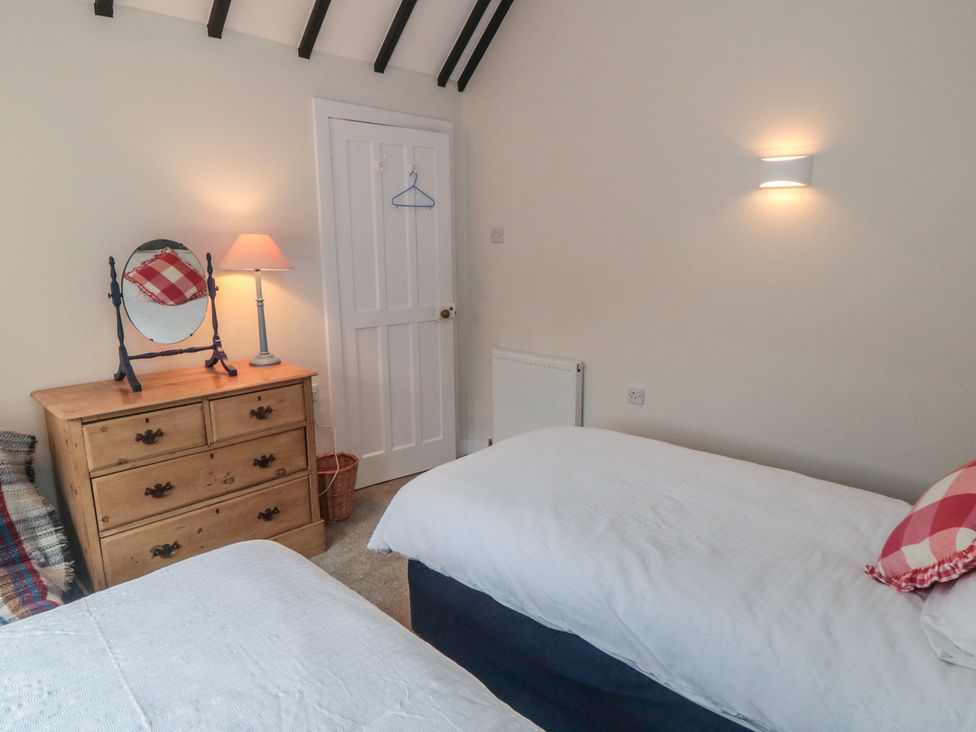 A bedroom with two beds and a dresser at Iveridge in Sandsend