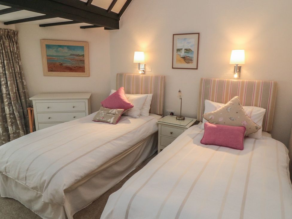 A bedroom with two beds and a chest of drawers at Iveridge Sandsend