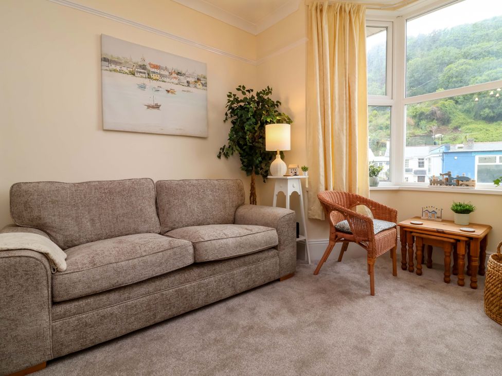 A living room with a sofa and a chair at Zide the Zea in Hele Bay, Ilfracombe