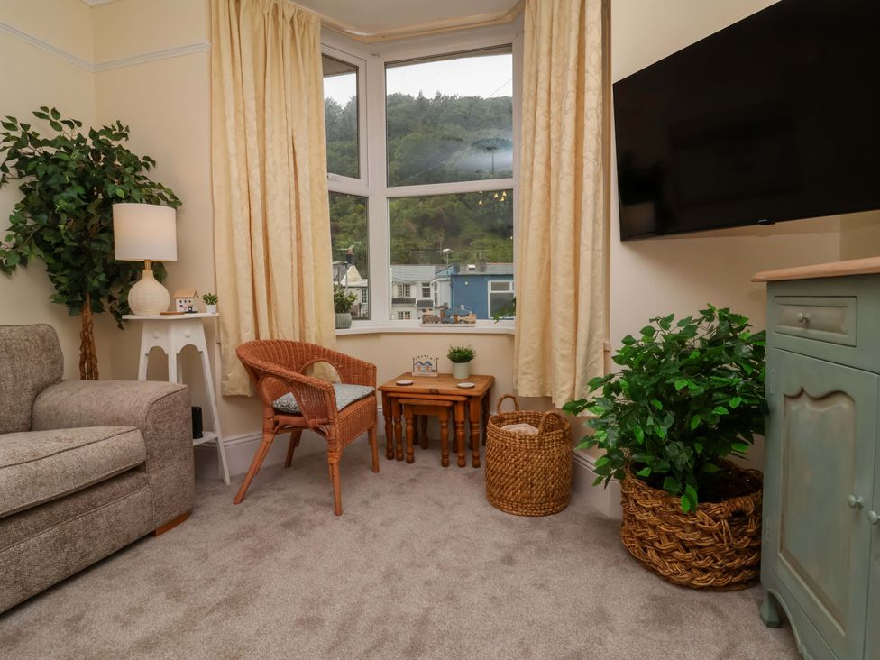 A living room with a sofa and television at Zide the Zea, Hele Bay, Ilfracombe