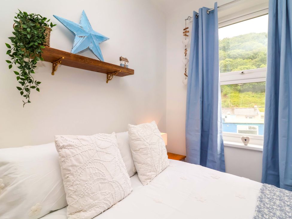 A bedroom with bed and star decoration at Zide the Zea, Hele Bay, Ilfracombe