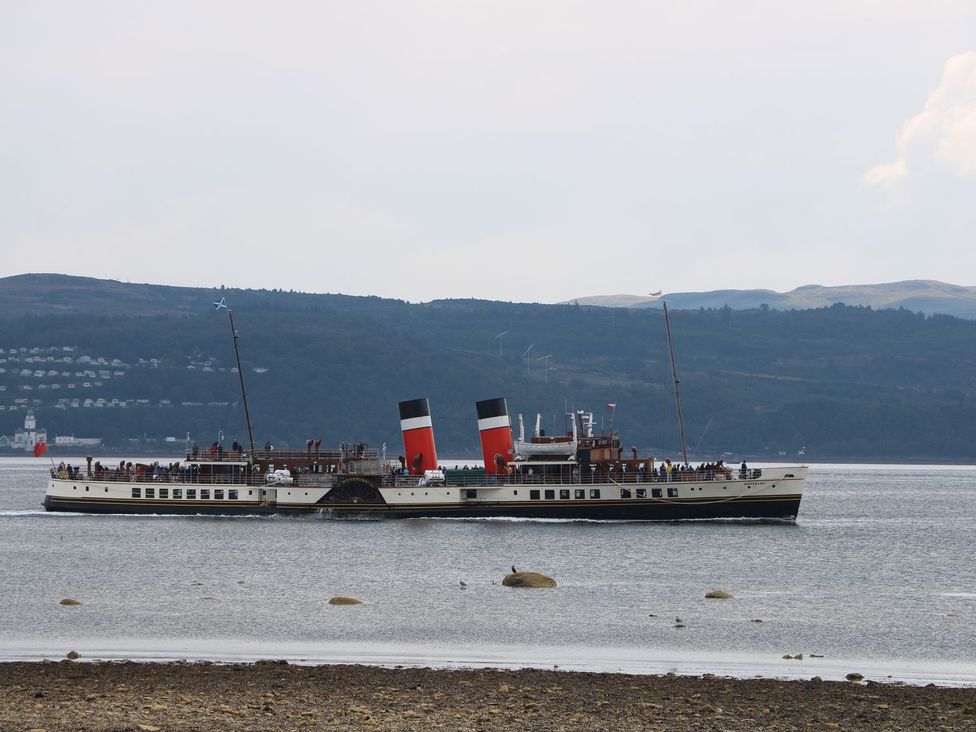 A paddle steamer boat on a body of water with hills in the background at Lenas Corner in Dunoon