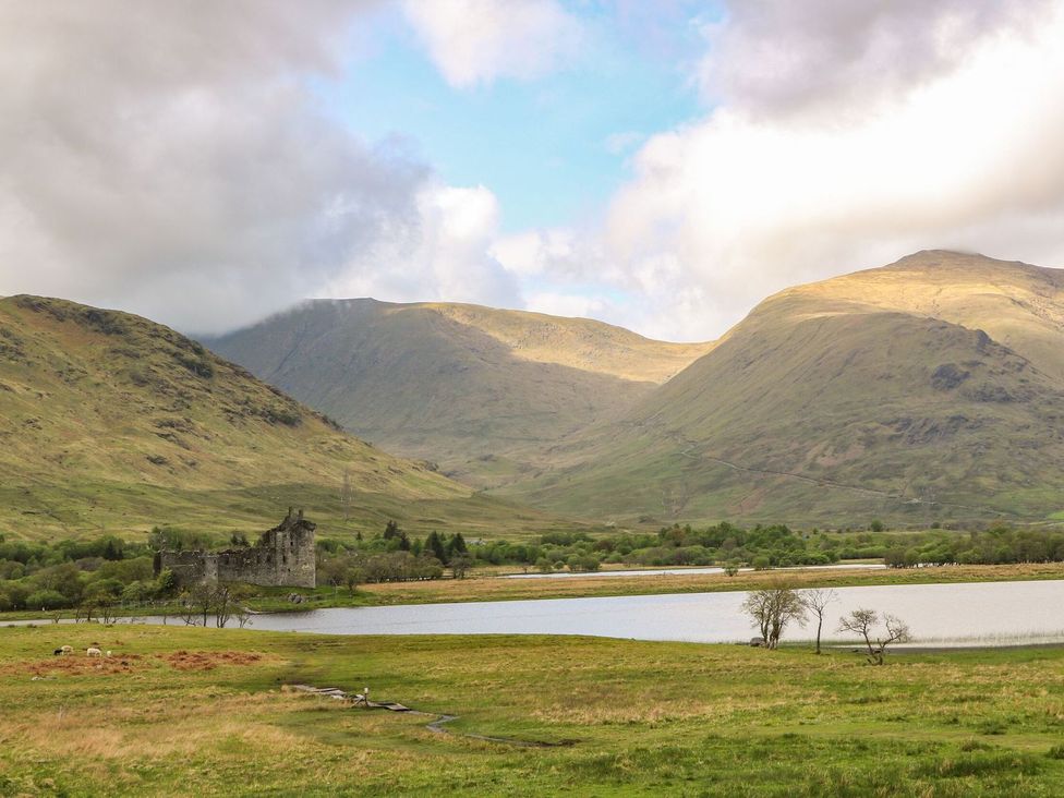 A landscape with mountains a lake an old stone castle and green fields with trees at Lena's Corner in Dunoon