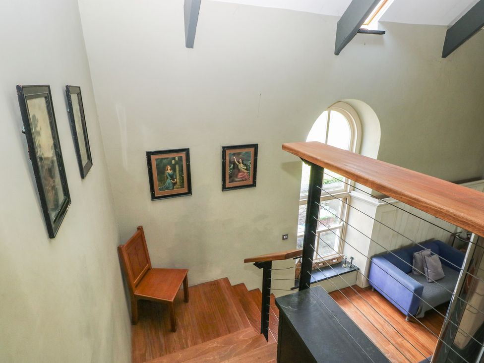A staircase with wooden steps and a wooden chair at Zoar Chapel in Carew
