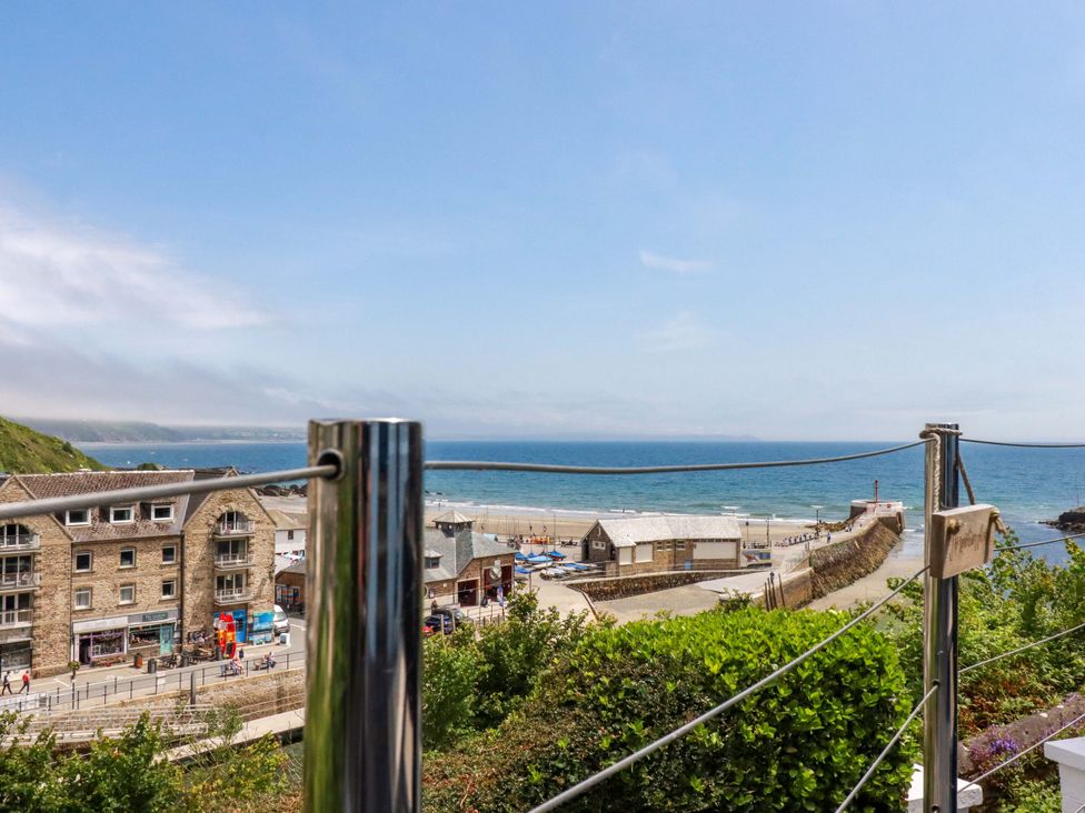 A view of the sea and buildings from an outdoor terrace at Harbour House in Looe